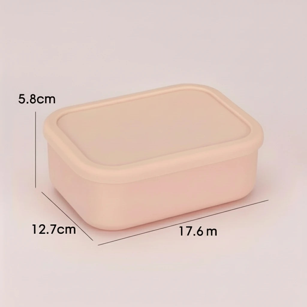 A set of pink silicone bento lunch boxes with leak-proof lids, containing various fruits and vegetables, presented on a table.